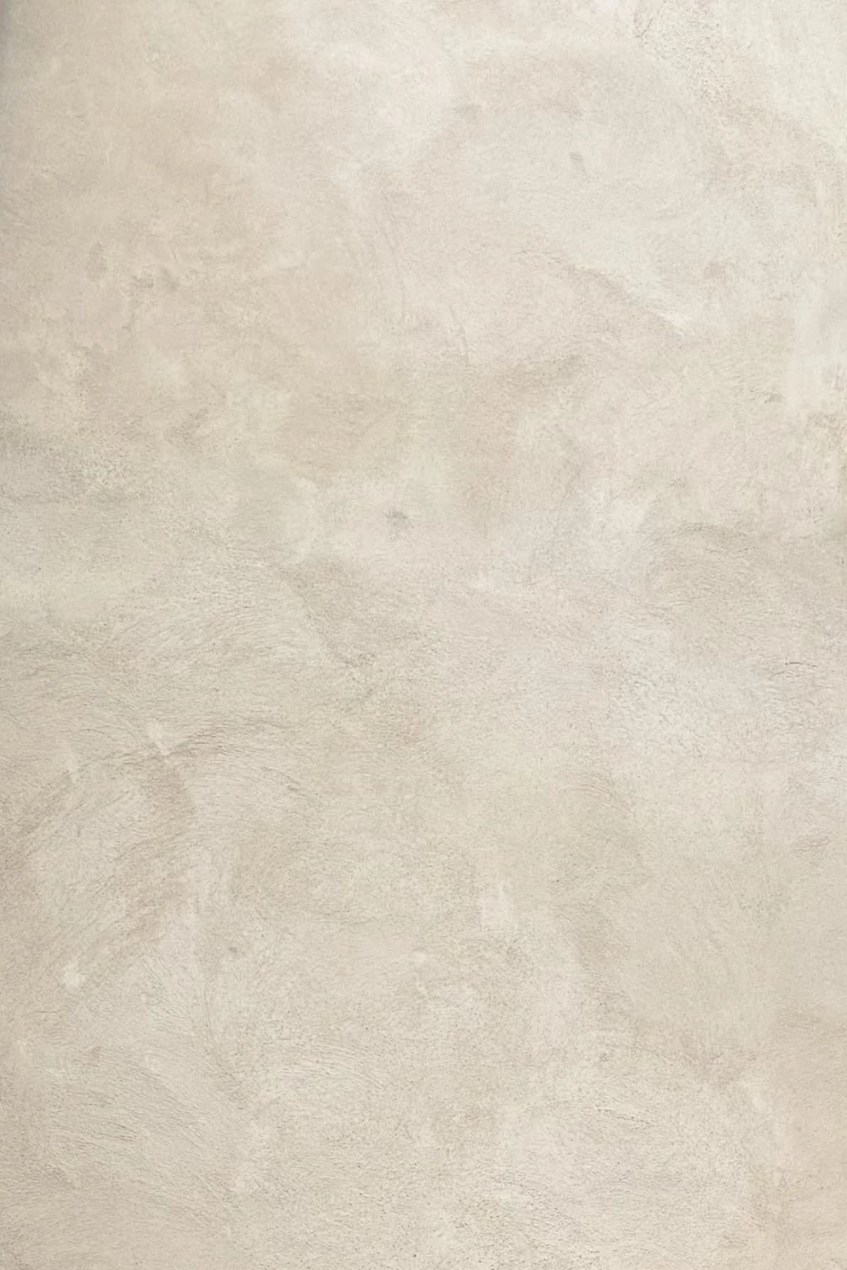Close view of a cream wall with a cloudy, layered brushed texture