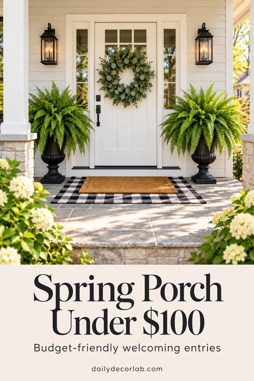 Spring front porch with wreath, layered doormats and Boston ferns in black urns