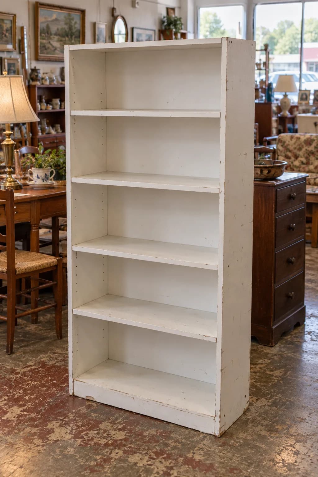 Laminate bookcase painted navy with wallpaper back before
